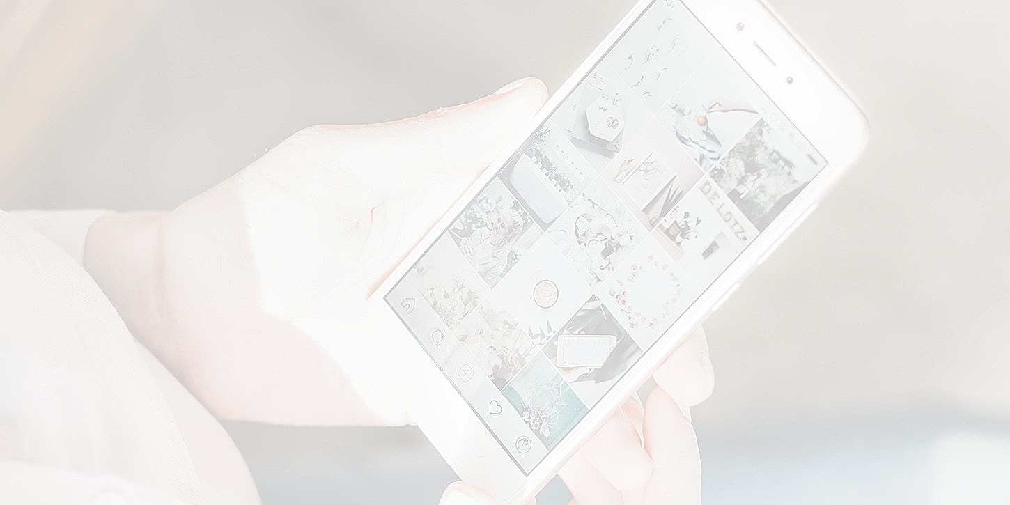 Person holding smartphone displaying social media app.