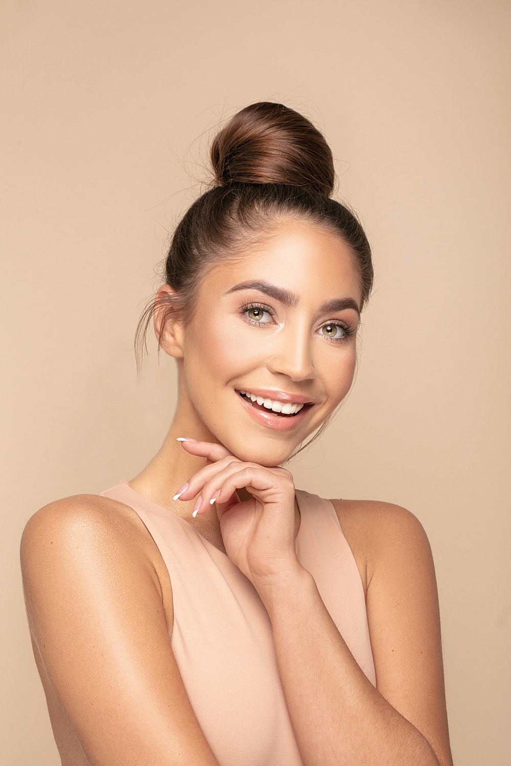 Smiling woman with freckles and curly hair.