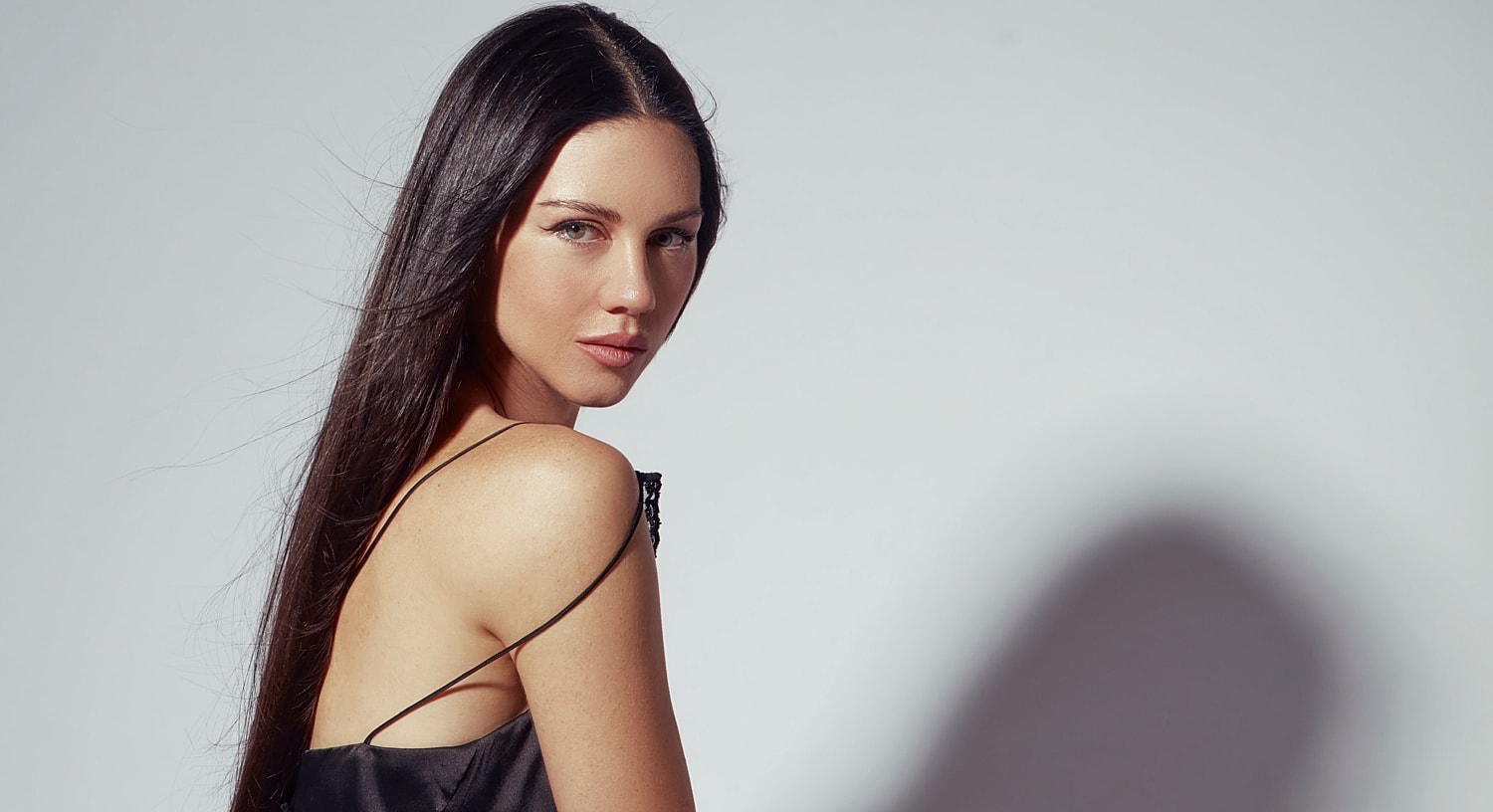 Model with wavy blonde hair and natural makeup.