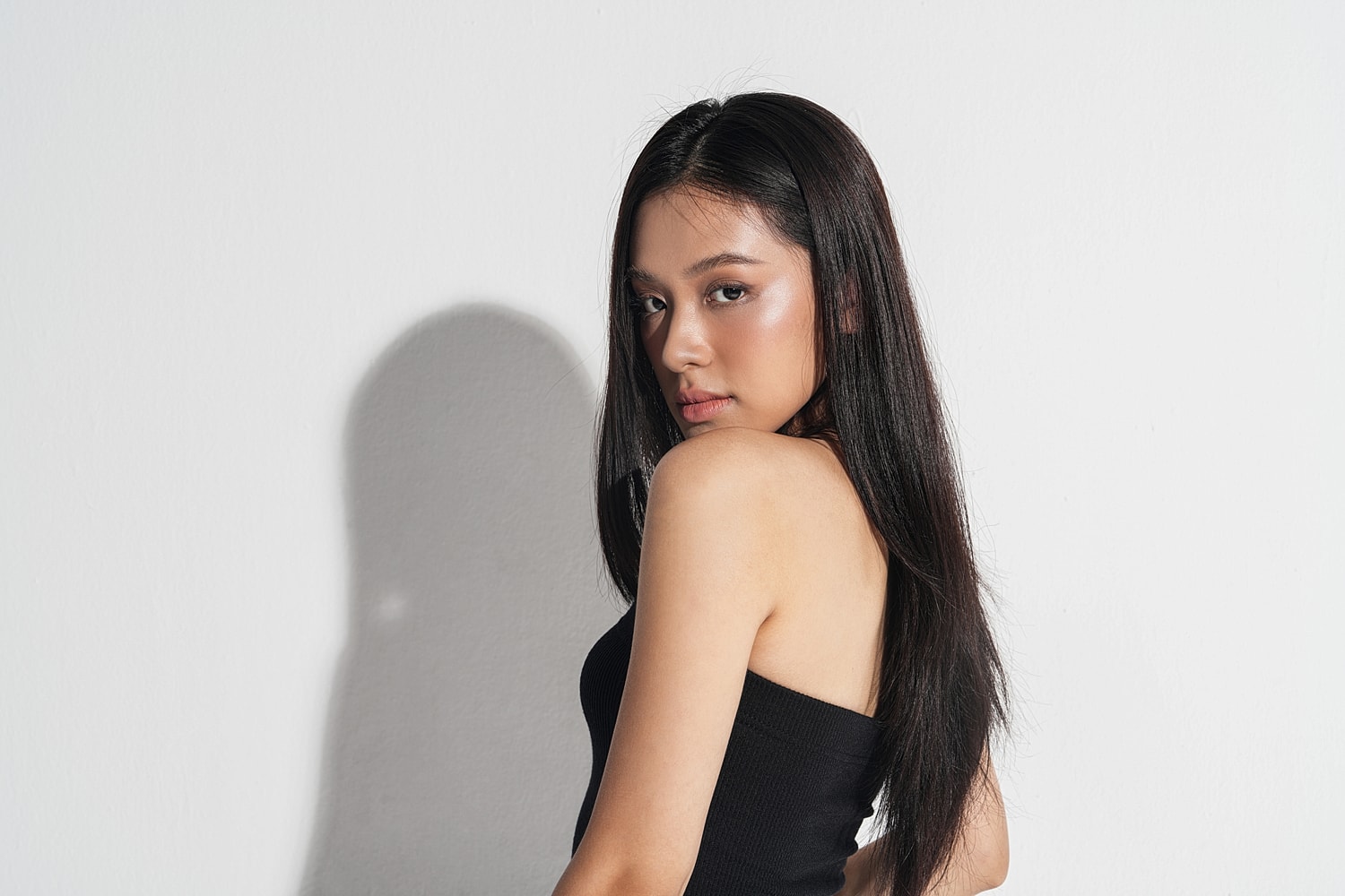 Woman with long hair in blue sweater.