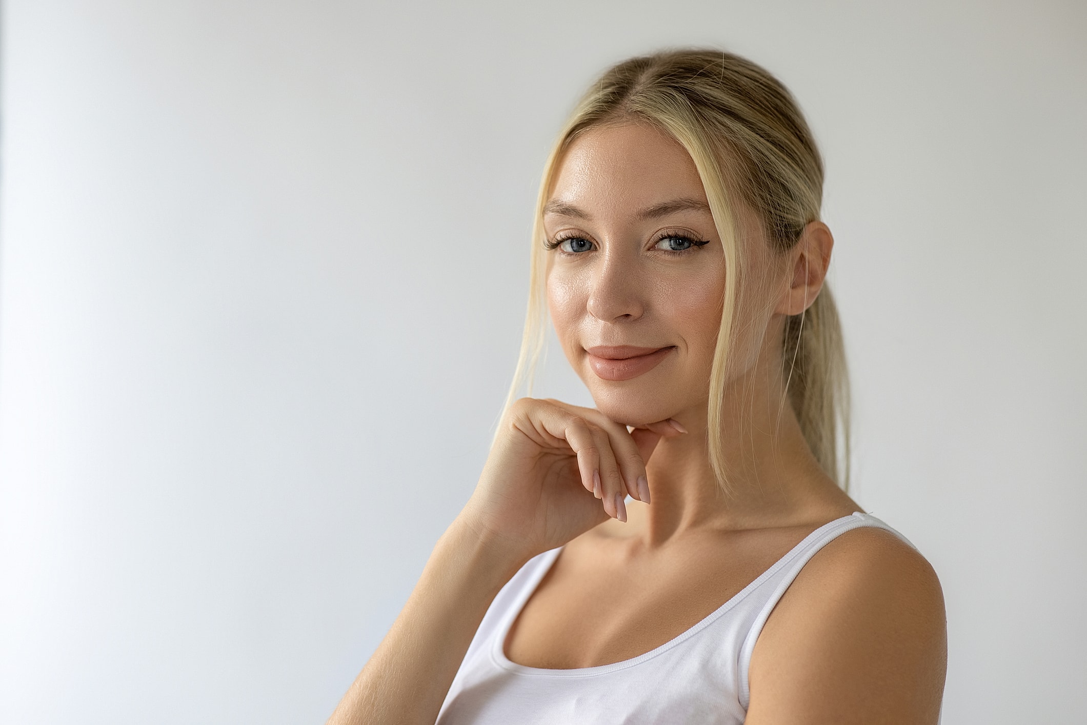 Smiling woman with light hair and soft makeup.