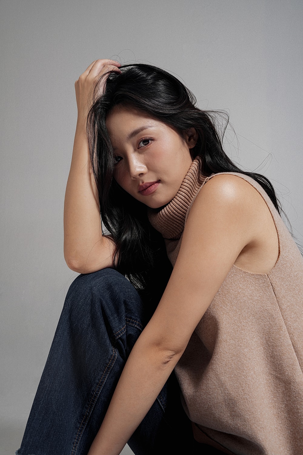 Woman with long black hair in casual pose.